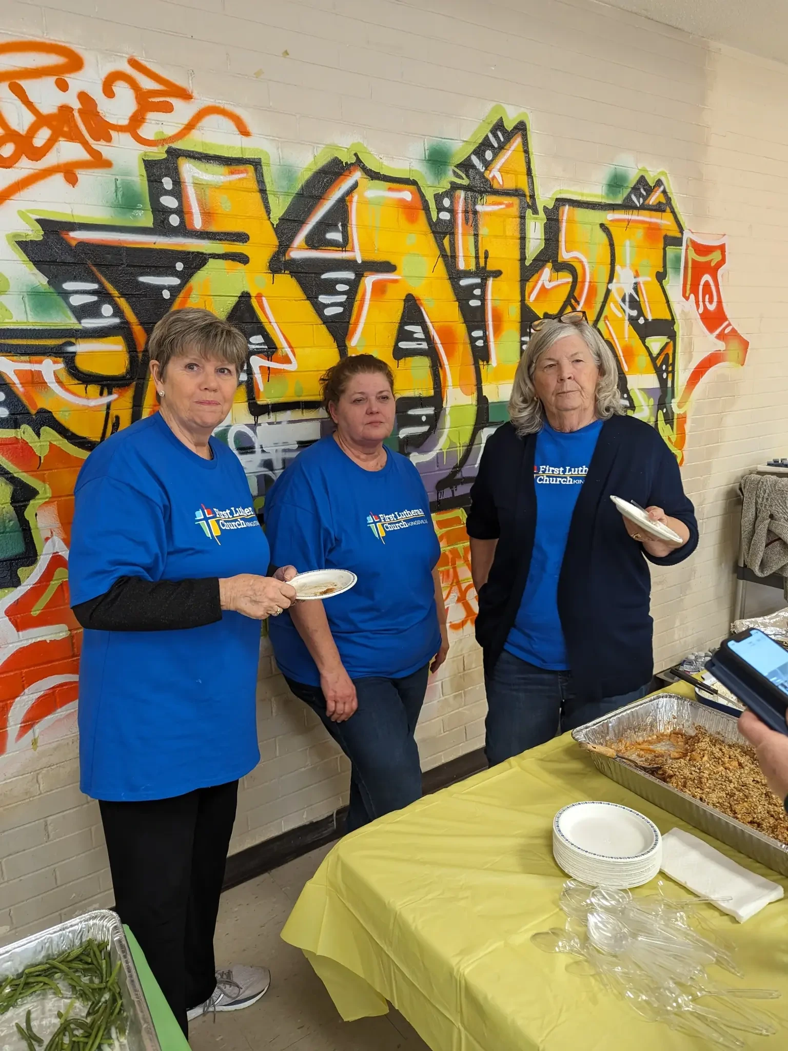 First Lutheran volunteers serving food in the community