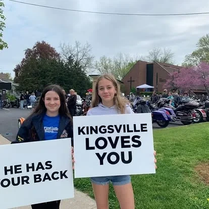 First Lutheran members holding a Kingsville Love You sign